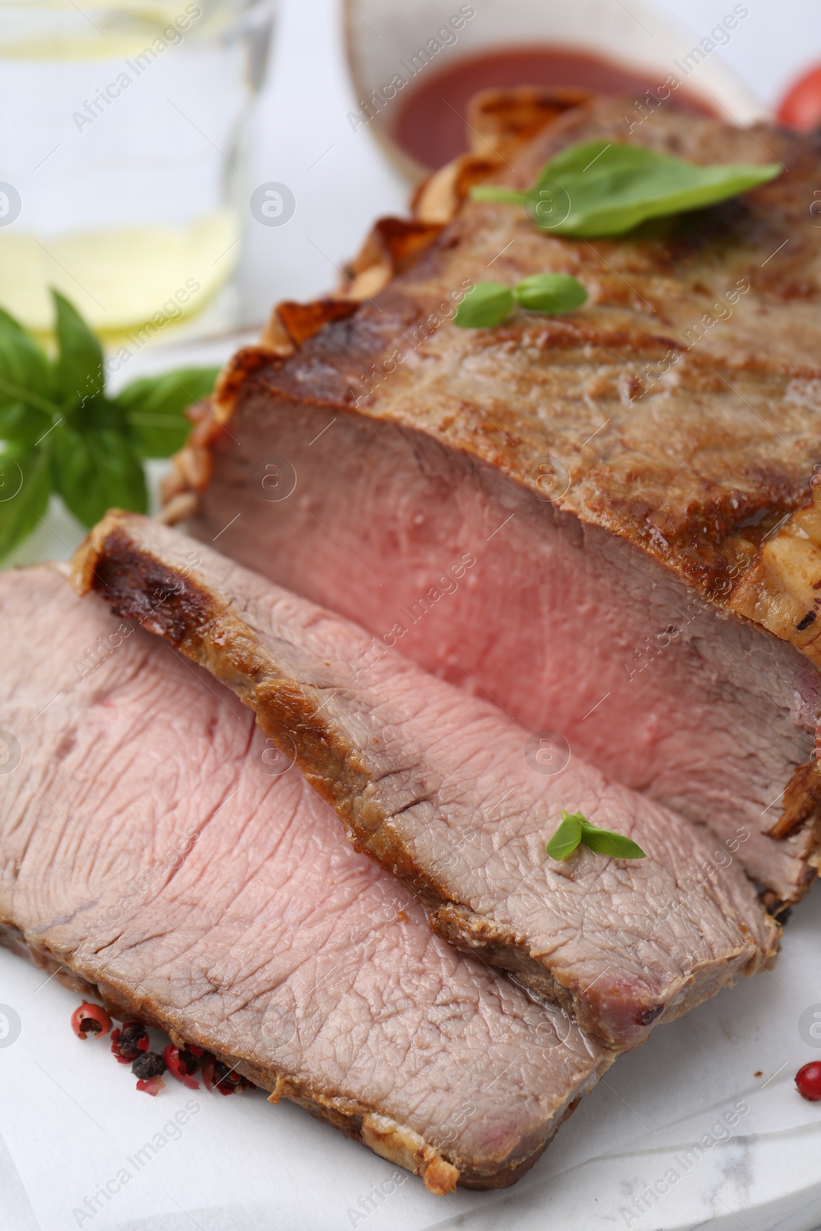 Delicious baked beef meat and spices on table, closeup Photo of Delicious baked beef meat and spices on table, closeup