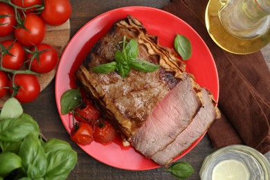 Photo of Delicious baked beef meat, tomatoes, basil and refreshing drink on wooden table, flat lay
