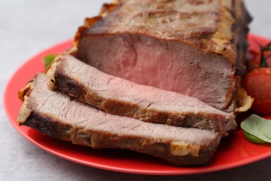 Photo of Delicious baked beef meat on grey table, closeup