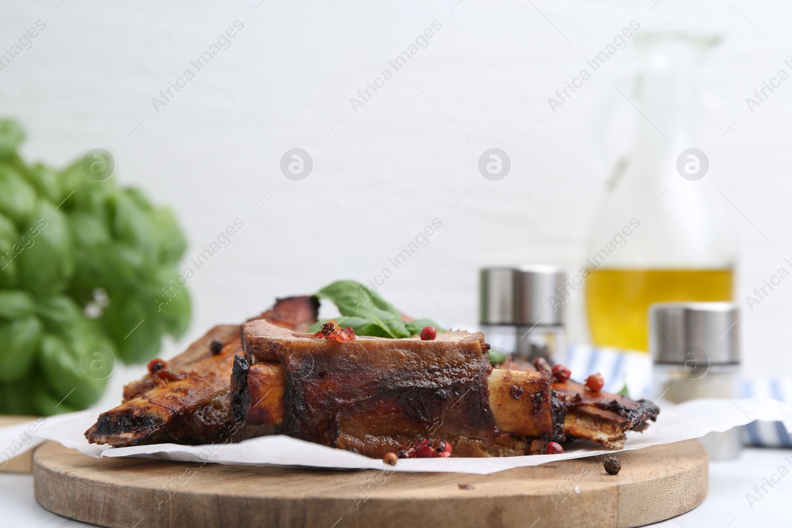 Roasted beef ribs with spices on white table, closeup Photo of Roasted beef ribs with spices on white table, closeup
