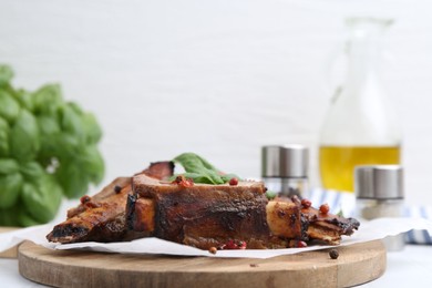 Photo of Roasted beef ribs with spices on white table, closeup