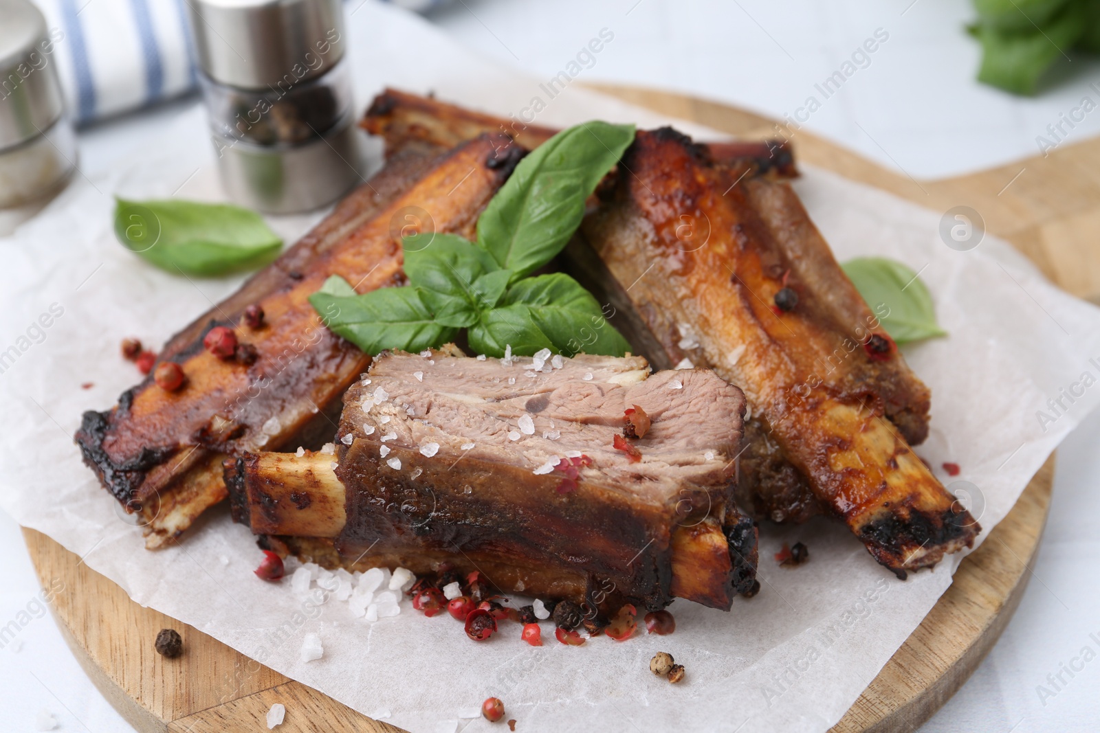 Roasted beef ribs with spices on table, closeup Photo of Roasted beef ribs with spices on table, closeup