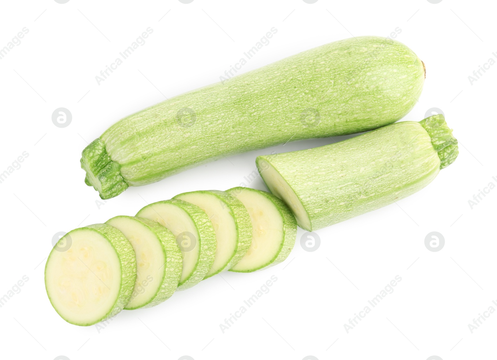 Photo of Fresh whole and cut zucchinis isolated on white, top view