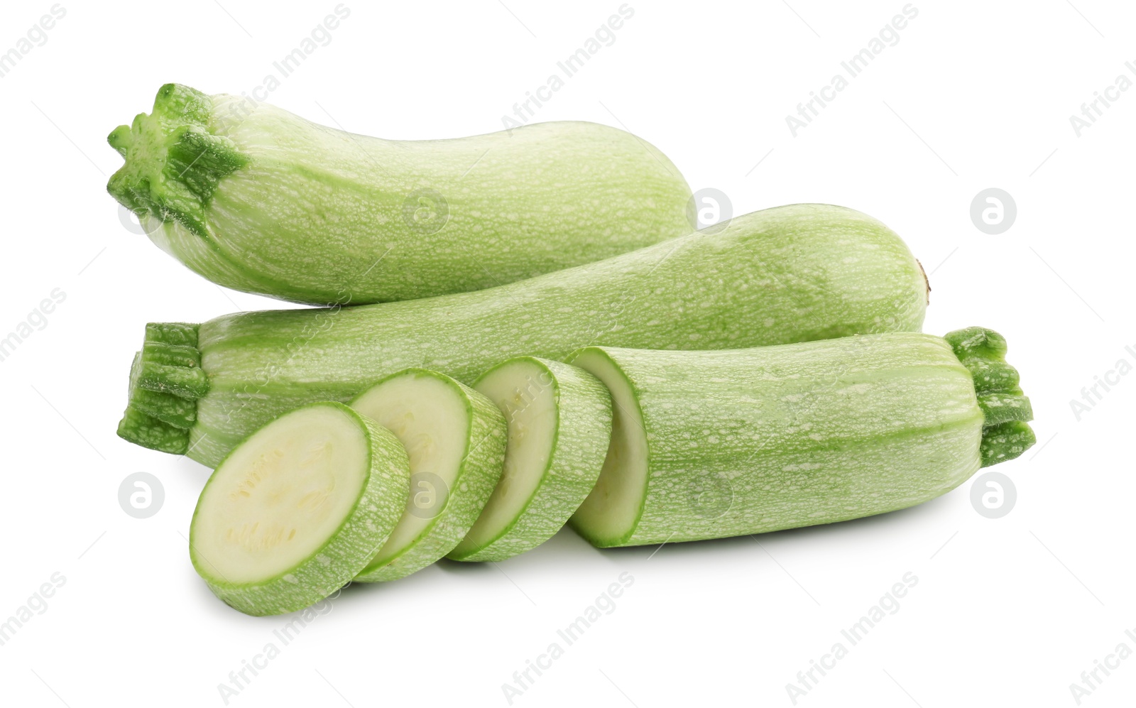 Photo of Fresh whole and cut zucchinis isolated on white
