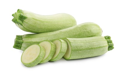 Photo of Fresh whole and cut zucchinis isolated on white