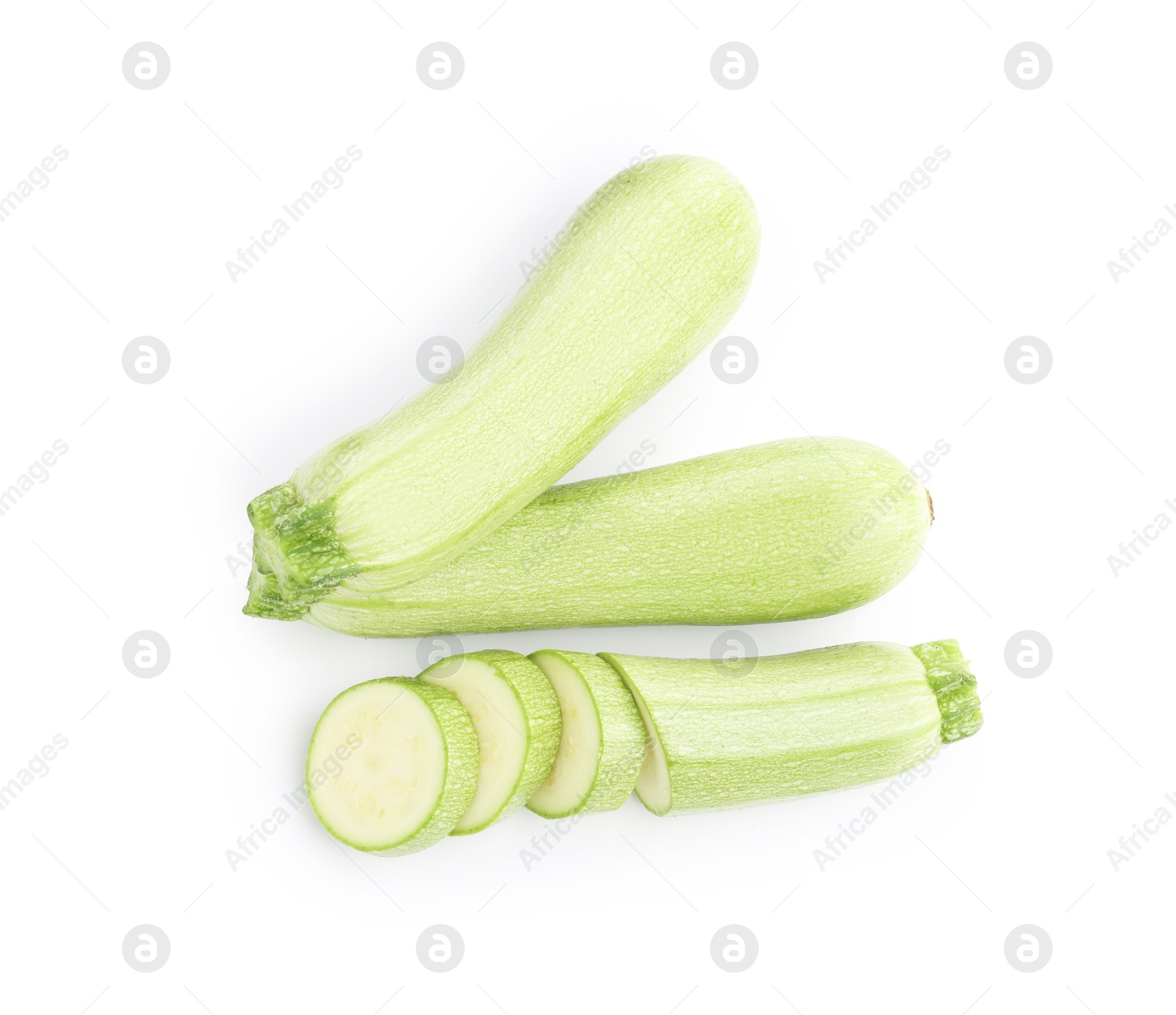 Photo of Fresh whole and cut zucchinis isolated on white, top view