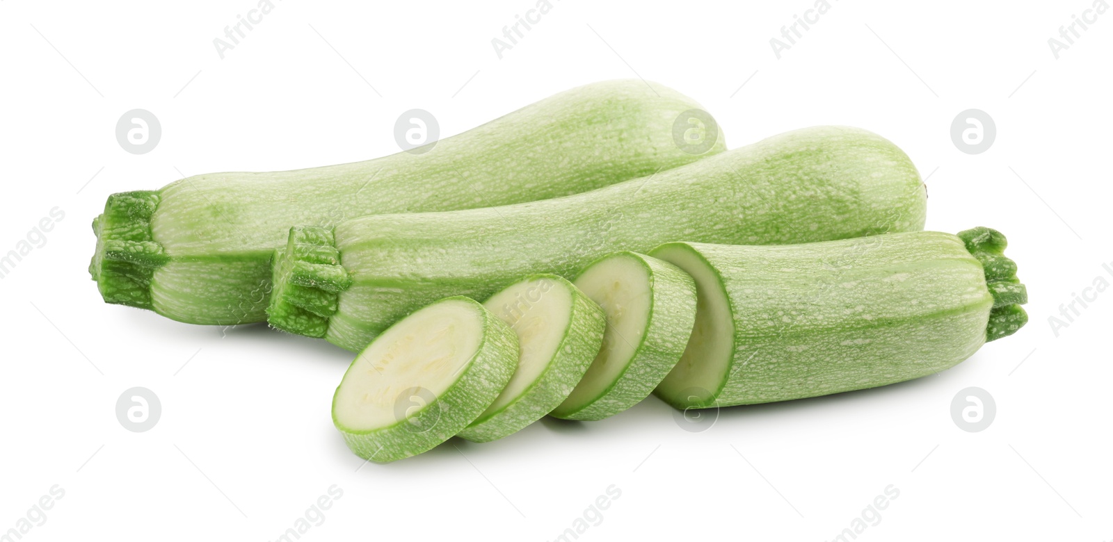 Photo of Fresh whole and cut zucchinis isolated on white