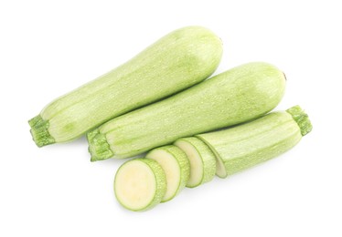 Photo of Fresh whole and cut zucchinis isolated on white, top view