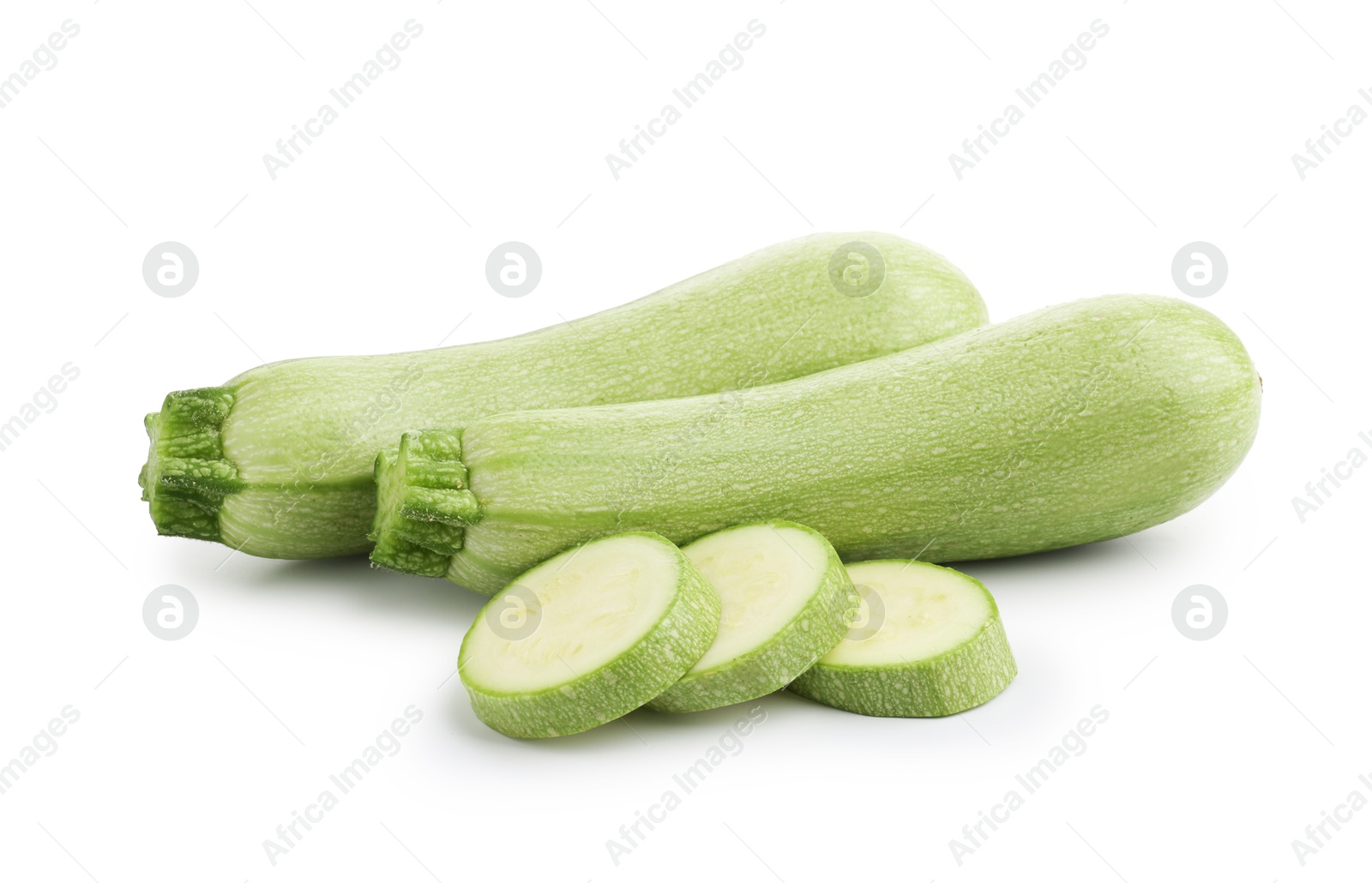 Photo of Fresh whole and cut zucchinis isolated on white