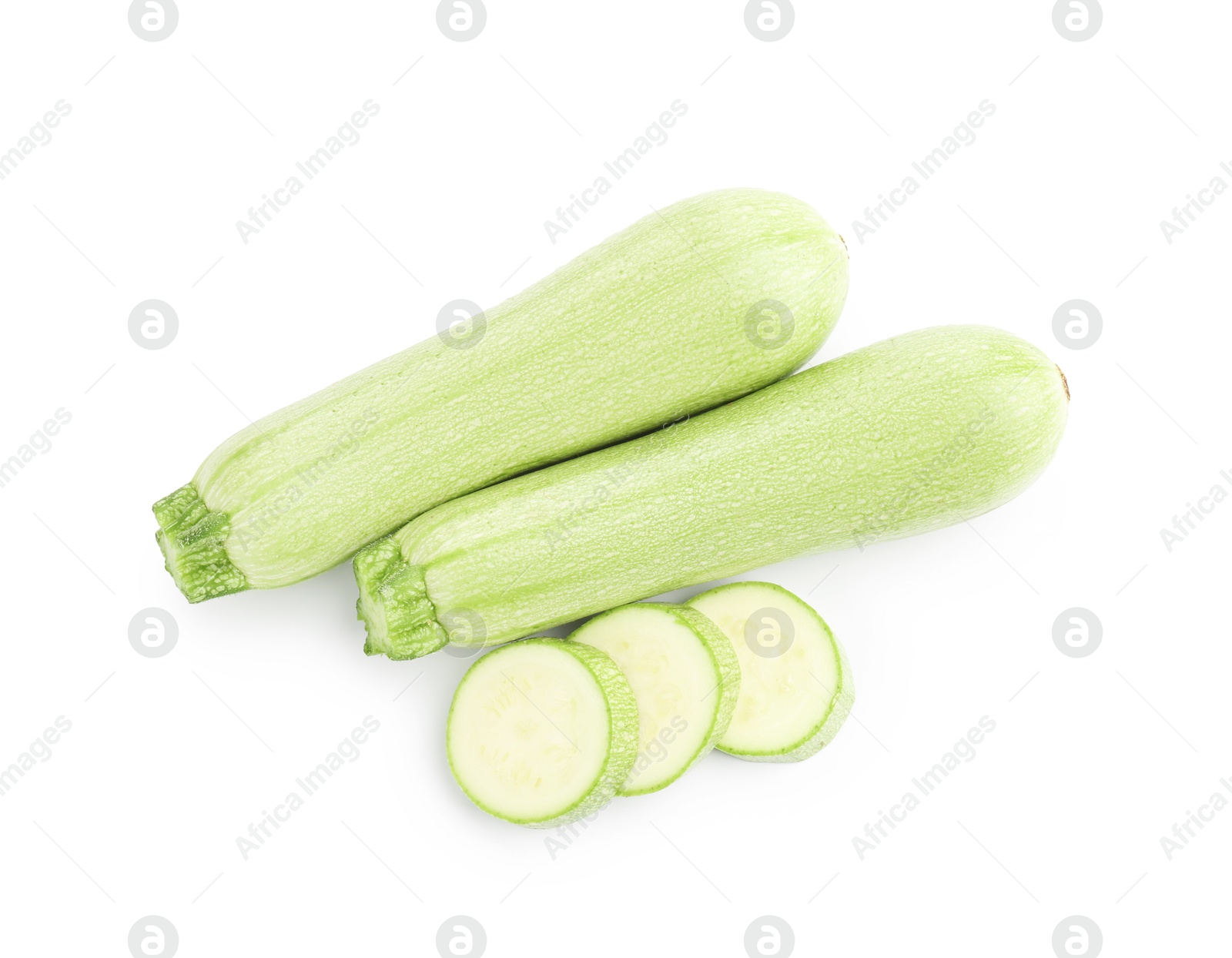 Photo of Fresh whole and cut zucchinis isolated on white, top view