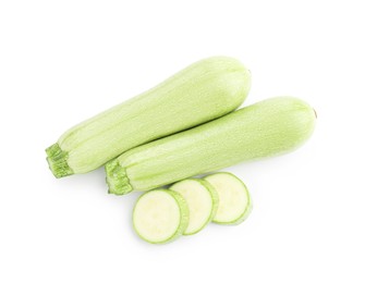 Photo of Fresh whole and cut zucchinis isolated on white, top view