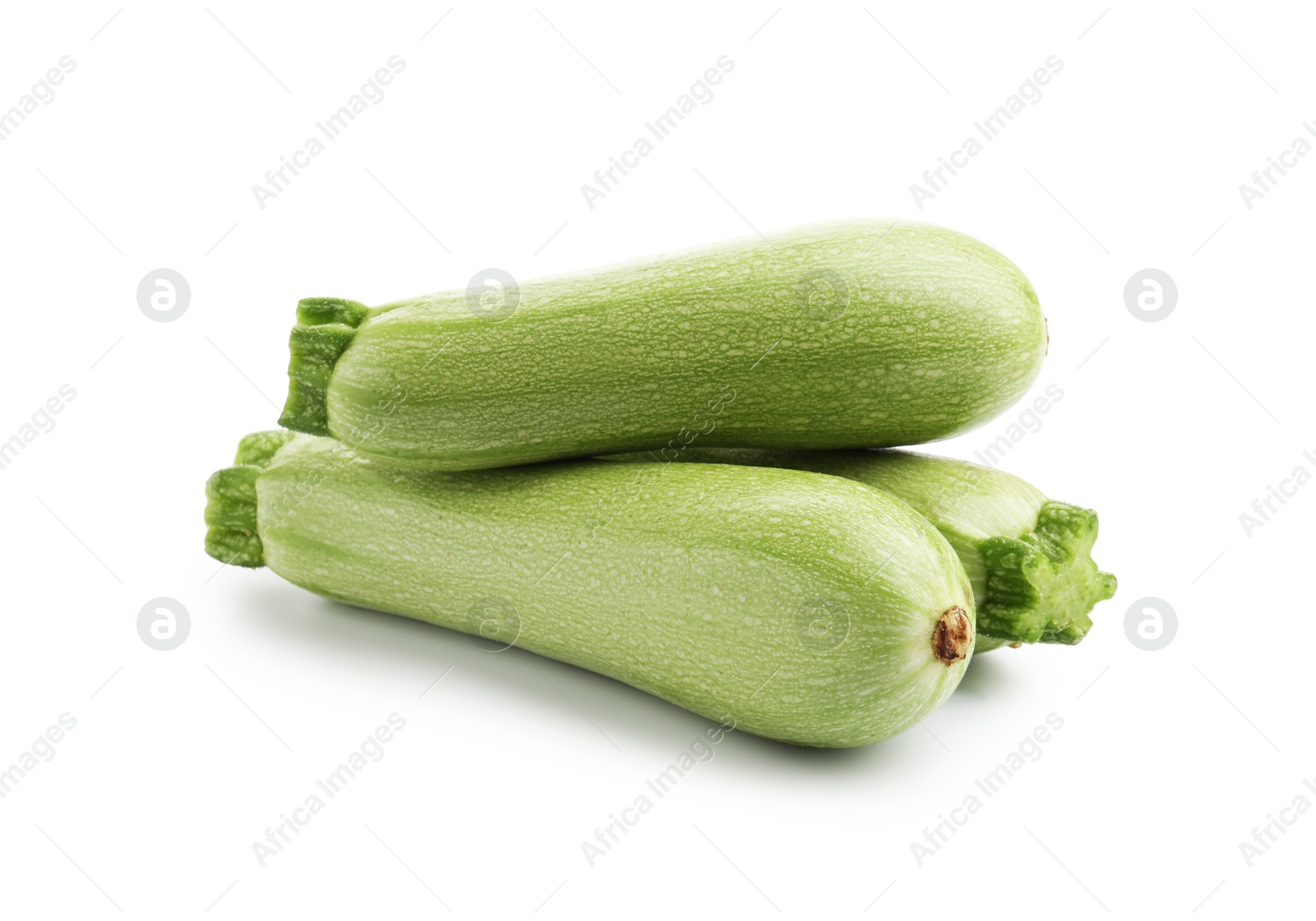 Photo of Many fresh ripe zucchinis isolated on white