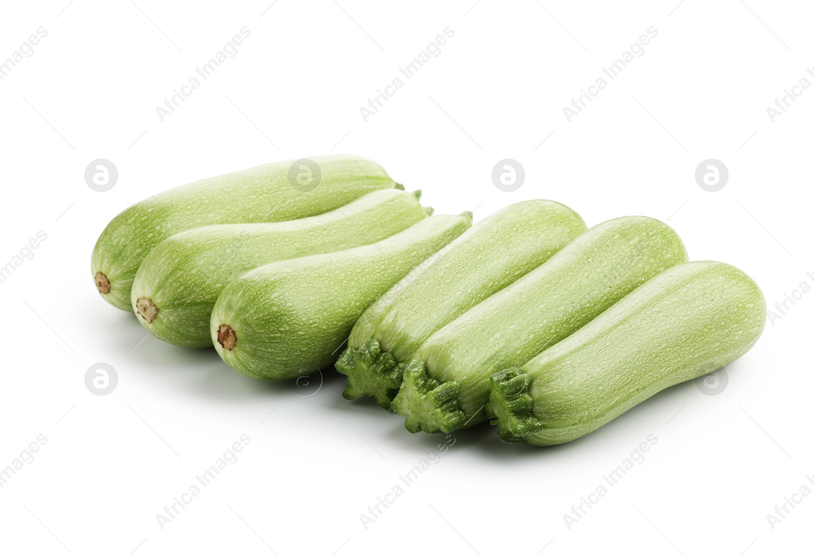 Photo of Many fresh ripe zucchinis isolated on white