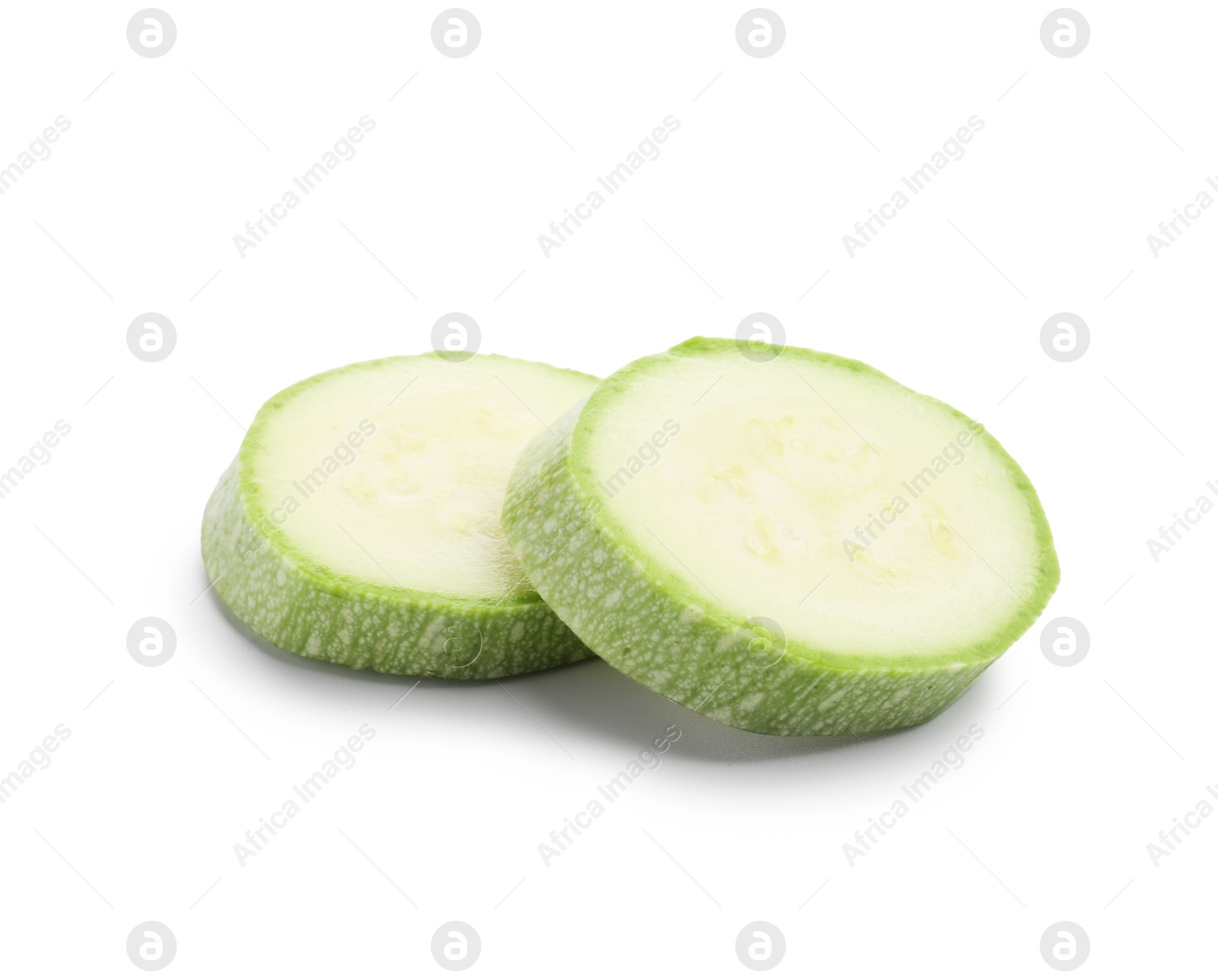 Slices of fresh zucchini isolated on white Photo of Slices of fresh zucchini isolated on white