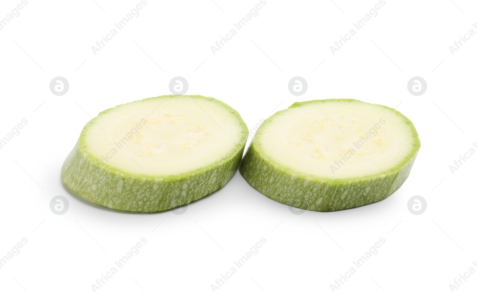 Slices of fresh zucchini isolated on white Photo of Slices of fresh zucchini isolated on white
