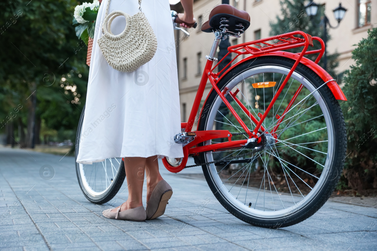 Woman near bicycle on city street, closeup Photo of Woman near bicycle on city street, closeup