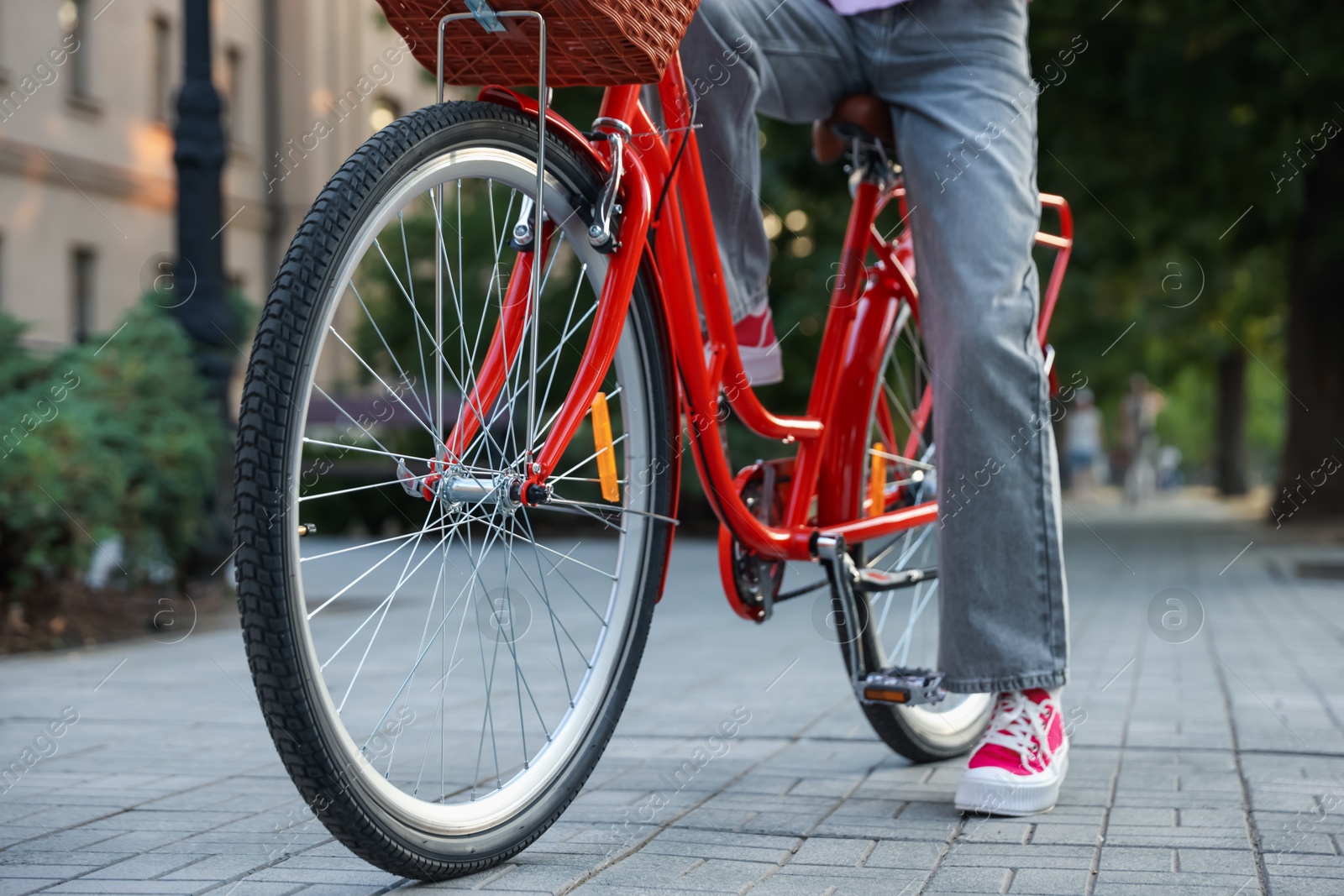 Teenage girl riding bicycle on city street, closeup Photo of Teenage girl riding bicycle on city street, closeup