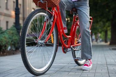 Photo of Teenage girl riding bicycle on city street, closeup