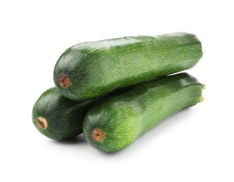 Photo of Three fresh ripe zucchinis isolated on white
