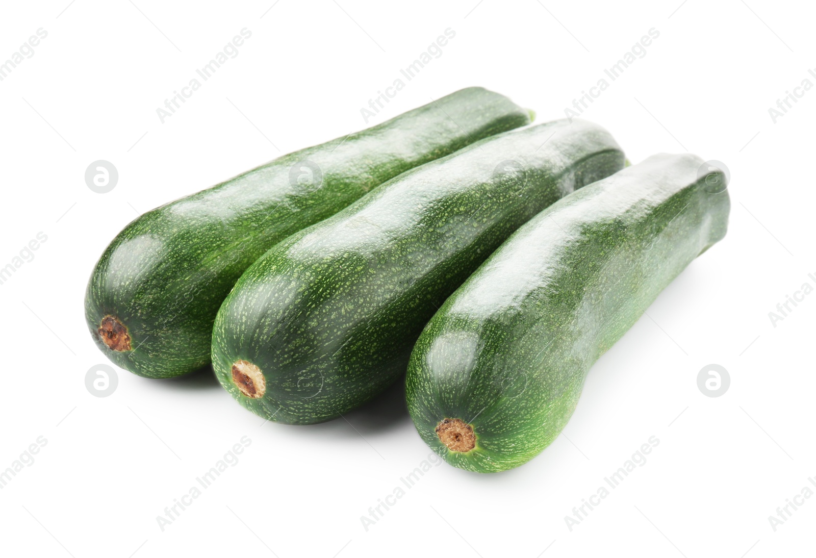 Three fresh ripe zucchinis isolated on white Photo of Three fresh ripe zucchinis isolated on white