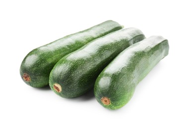 Photo of Three fresh ripe zucchinis isolated on white