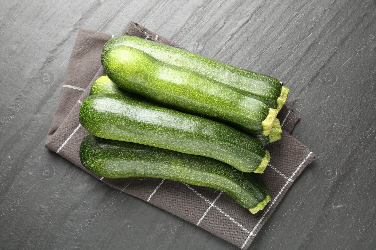 Fresh ripe zucchinis on black table, top view Photo of Fresh ripe zucchinis on black table, top view