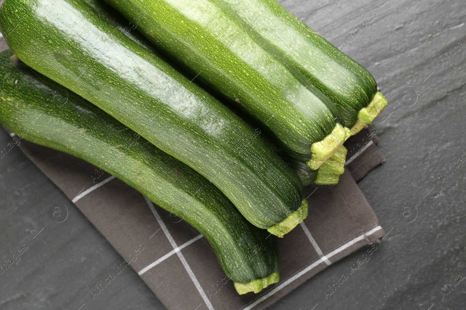 Fresh ripe zucchinis on black table, top view Photo of Fresh ripe zucchinis on black table, top view