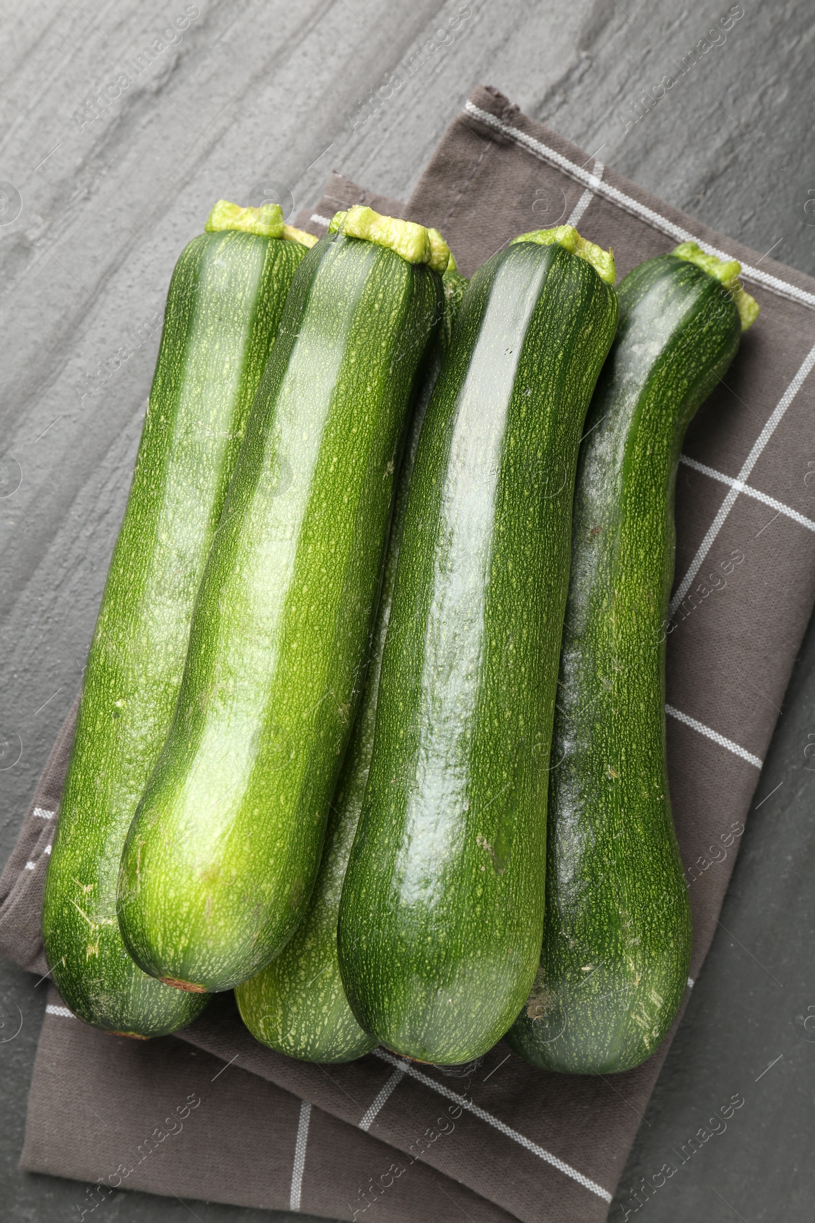 Fresh ripe zucchinis on black table, top view Photo of Fresh ripe zucchinis on black table, top view