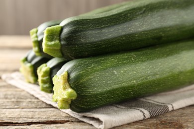 Photo of Fresh ripe zucchinis on wooden table, closeup