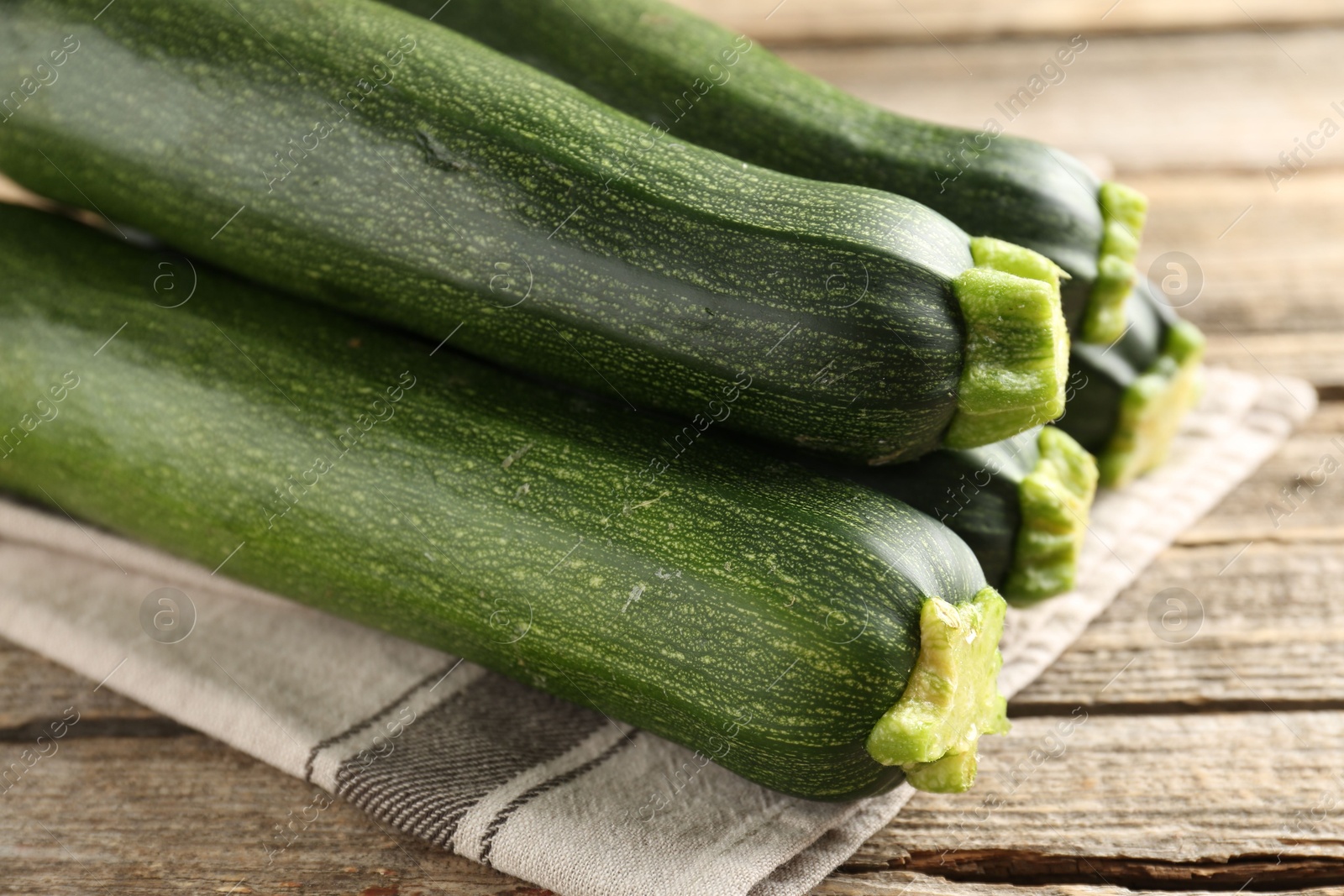 Fresh ripe zucchinis on wooden table, closeup Photo of Fresh ripe zucchinis on wooden table, closeup