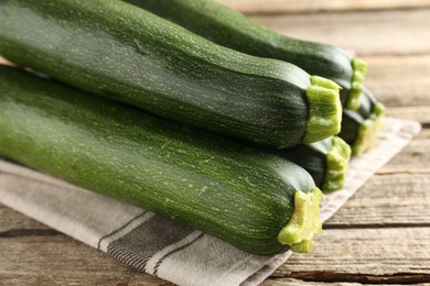Photo of Fresh ripe zucchinis on wooden table, closeup