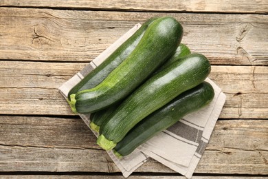 Photo of Fresh ripe zucchinis on wooden table, top view