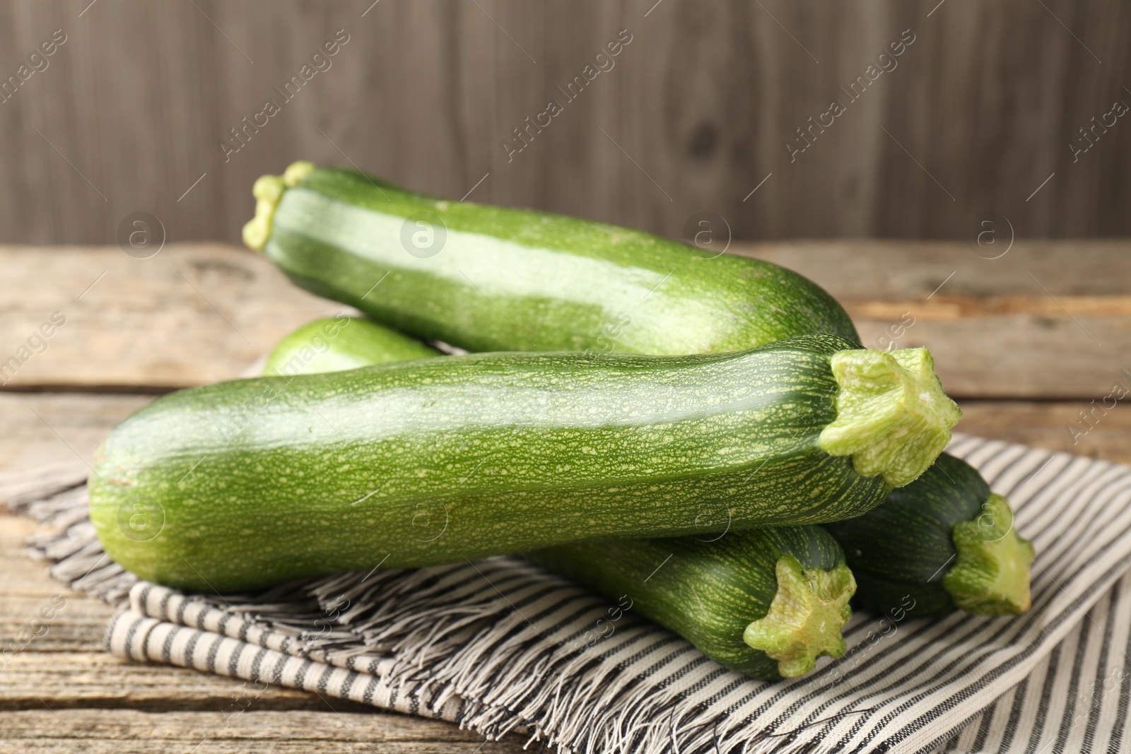 Fresh ripe zucchinis on wooden table, closeup Photo of Fresh ripe zucchinis on wooden table, closeup