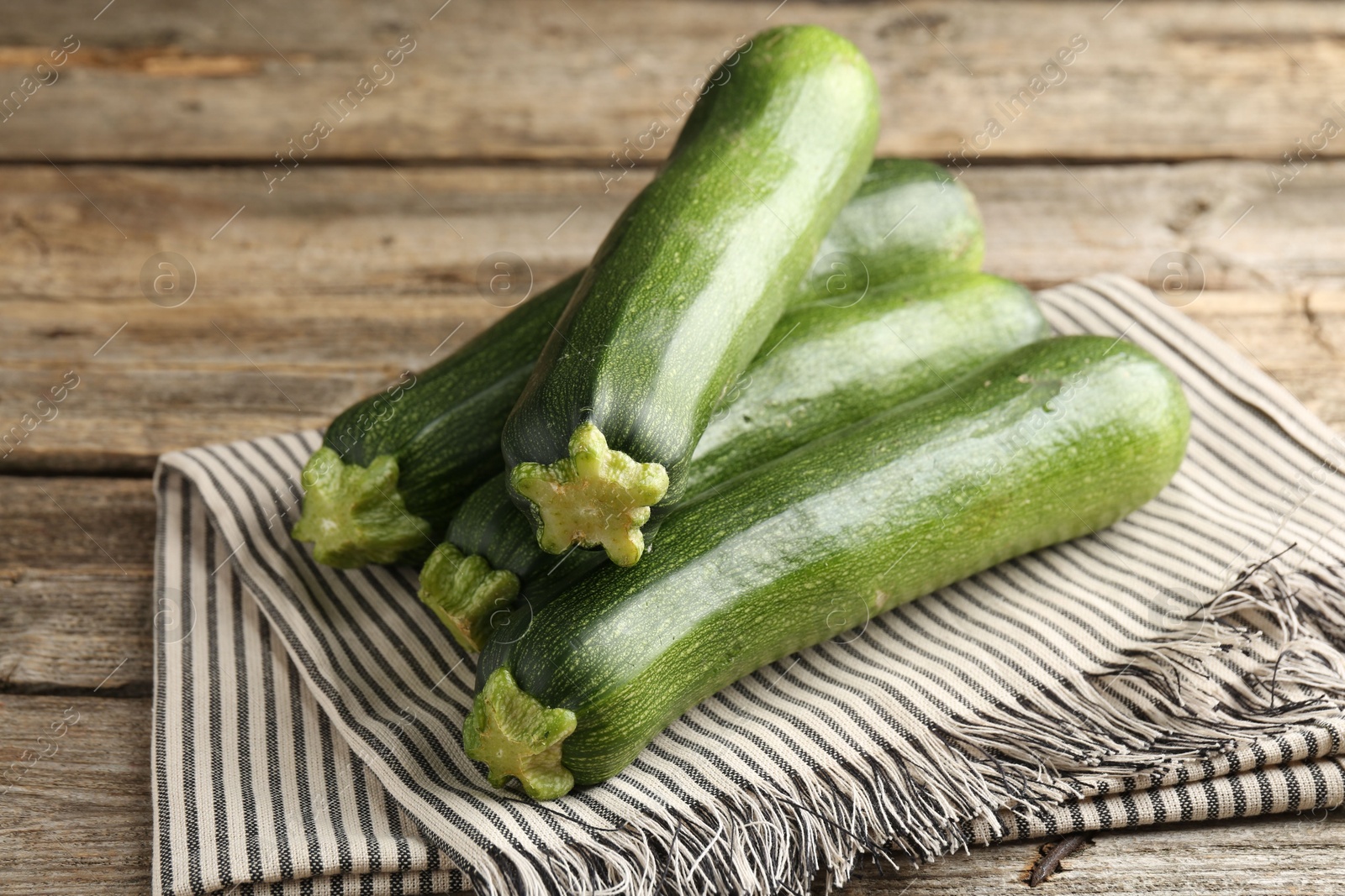 Fresh ripe zucchinis on wooden table, closeup Photo of Fresh ripe zucchinis on wooden table, closeup