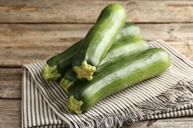 Photo of Fresh ripe zucchinis on wooden table, closeup