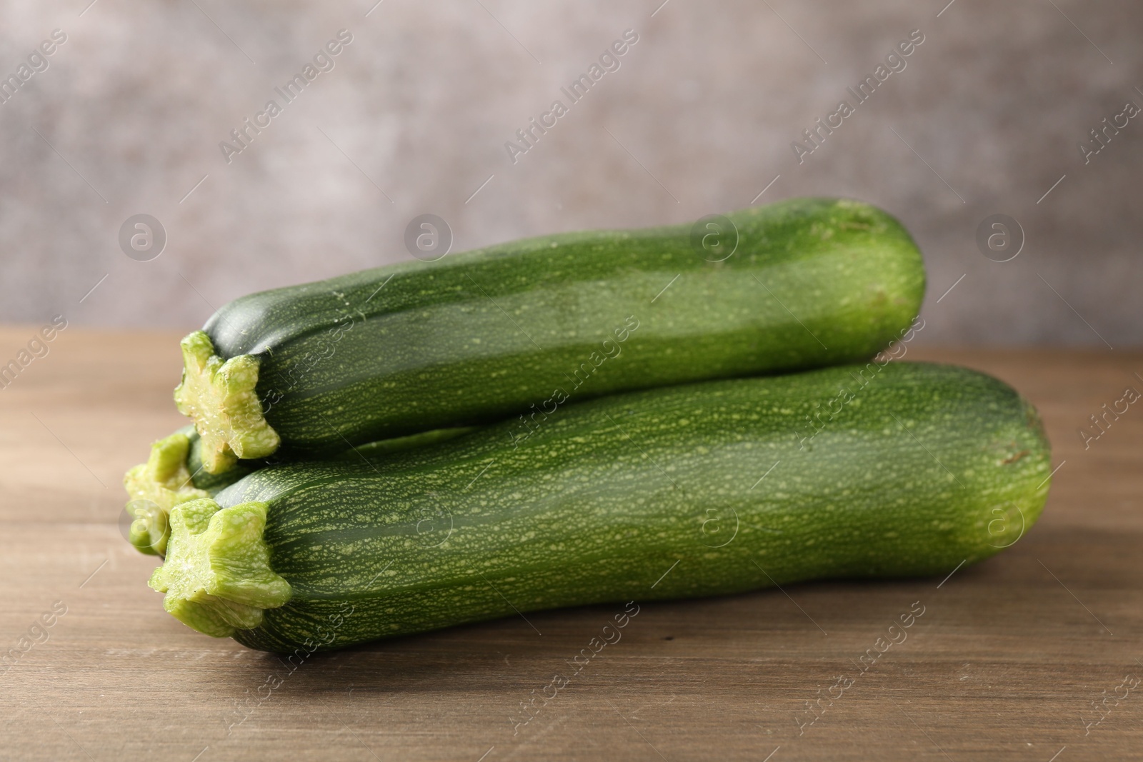 Fresh ripe zucchinis on wooden table, closeup Photo of Fresh ripe zucchinis on wooden table, closeup