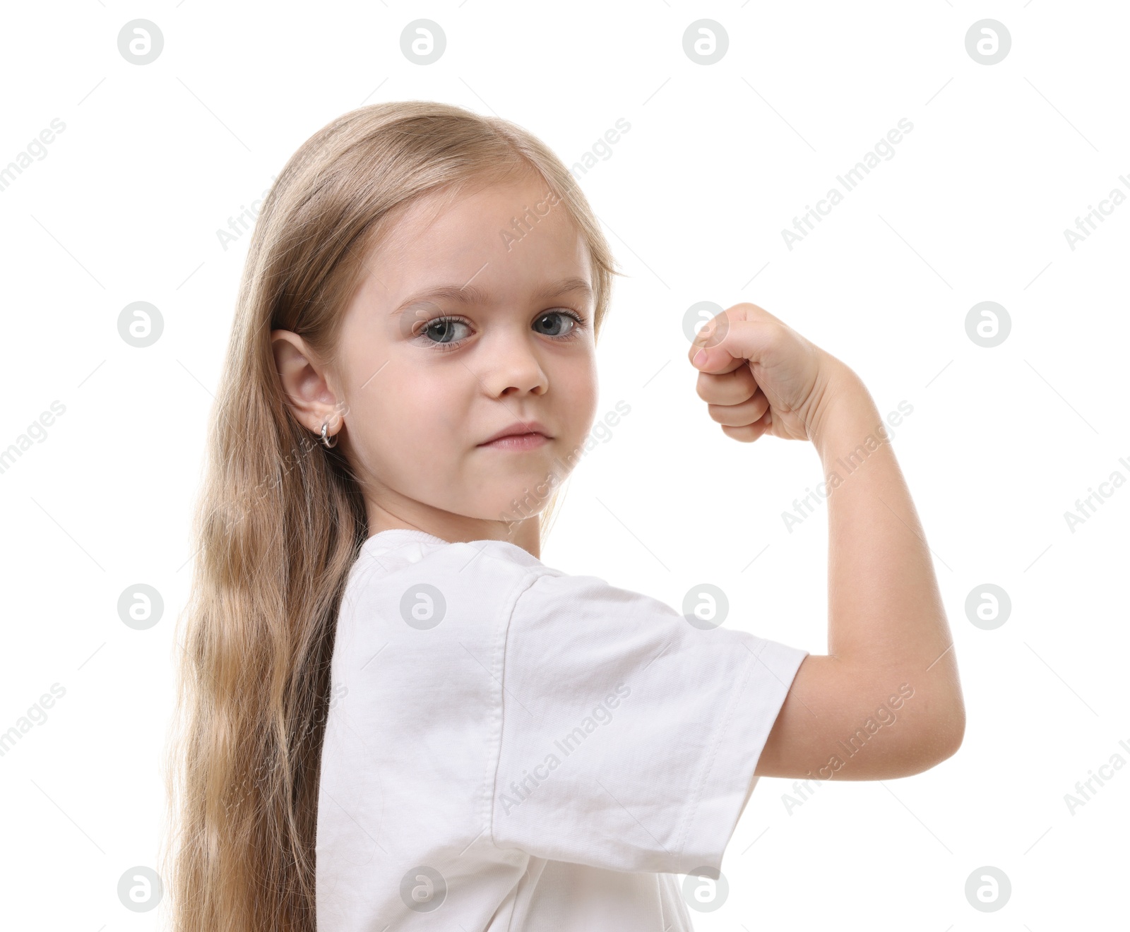 Strength. Happy little girl showing her biceps on white background Photo of Strength. Happy little girl showing her biceps on white background