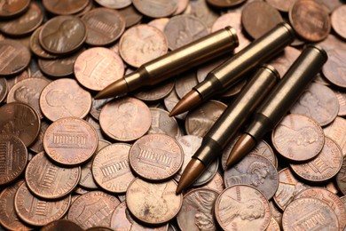 Photo of Many firearm cartridges on coins, closeup view