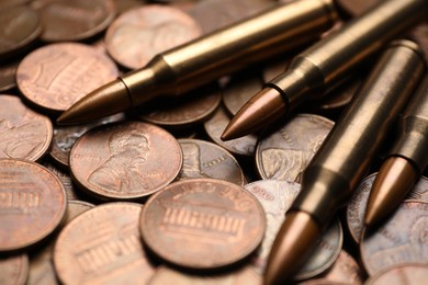 Photo of Many firearm cartridges on coins, closeup view