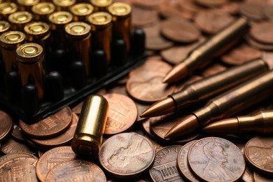 Photo of Many firearm cartridges on coins, closeup view