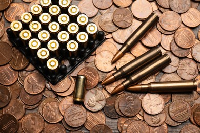 Photo of Many firearm cartridges on coins, top view