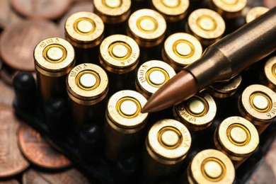Photo of Many firearm cartridges on coins, closeup view