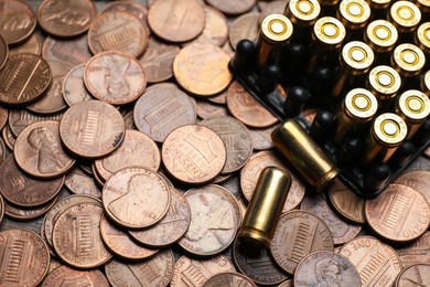 Photo of Many firearm cartridges on coins, closeup view