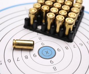Photo of Firearm cartridges on paper target, closeup view