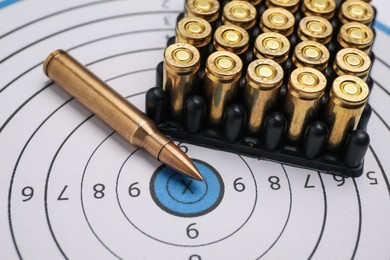 Photo of Firearm cartridges on paper target, closeup view