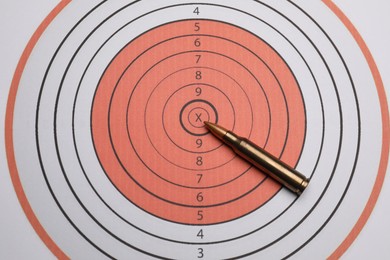 Photo of Firearm cartridge on paper target, top view