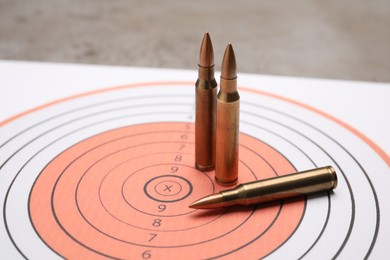 Photo of Firearm cartridges on paper target, closeup view