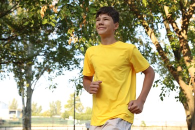 Photo of Teenage boy running in park. Training outdoors