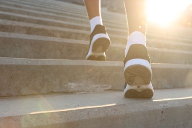 Photo of Teenage boy running up stairs outdoors, closeup