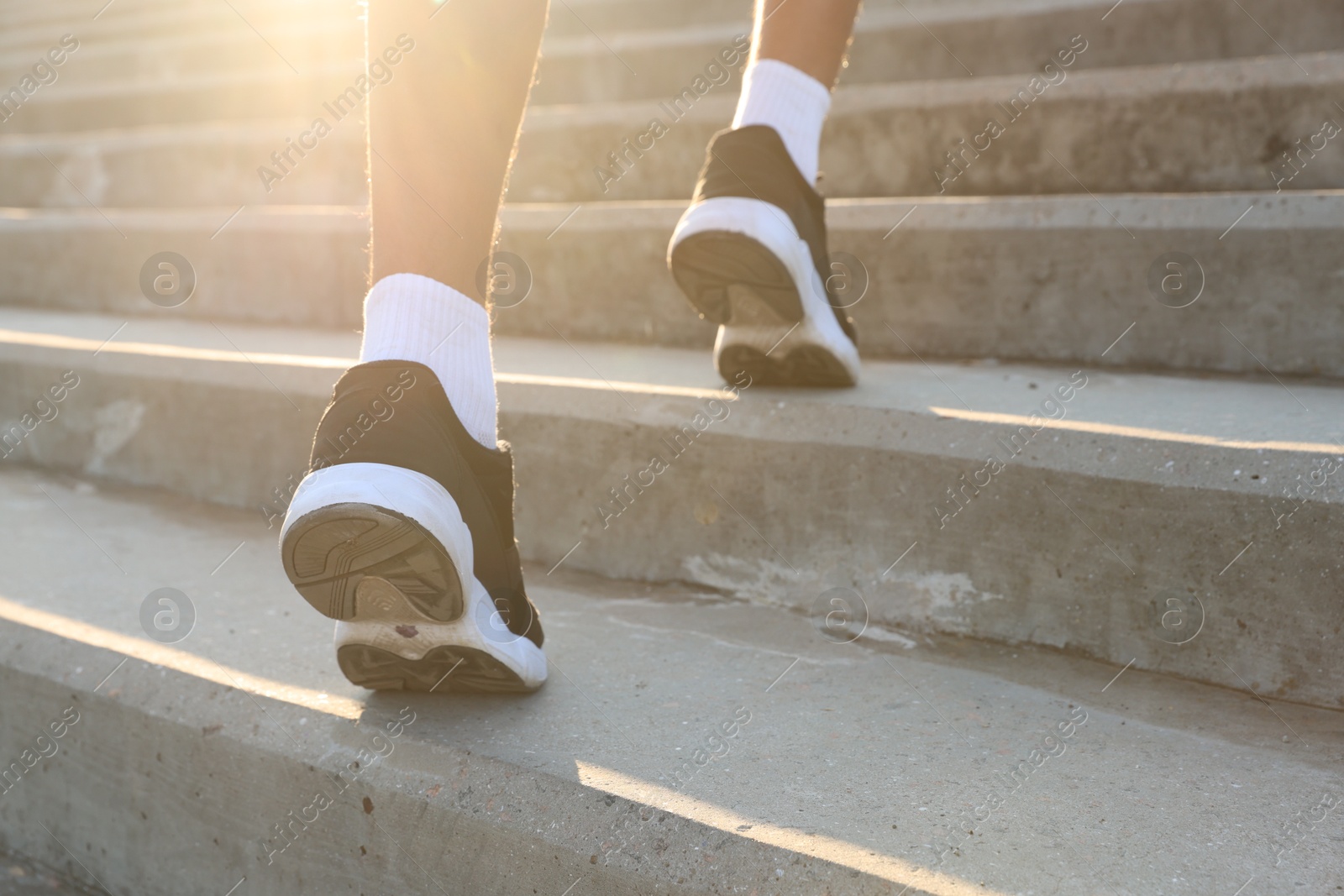 Teenage boy running up stairs outdoors, closeup Photo of Teenage boy running up stairs outdoors, closeup